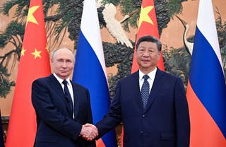 Russian president Vladimir Putin and Chinese president Xi Jinping pose for photos before their meeting in Beijing